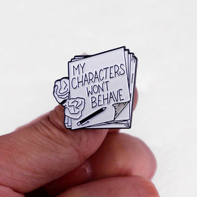The "My Characters Won't Behave" Enamel Pin is an average-sized brooch featuring a stylised stack of pen and papers, with pile of crumpled sheets to pay tribute to just how naughty your characters are today. Only one way to get them back in order... keep going!