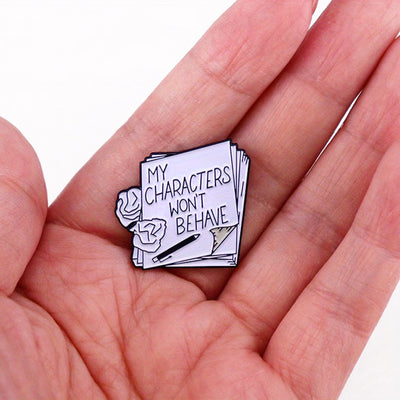 The "My Characters Won't Behave" Enamel Pin is an average-sized brooch featuring a stylised stack of pen and papers, with pile of crumpled sheets to pay tribute to just how naughty your characters are today. Only one way to get them back in order... keep going!