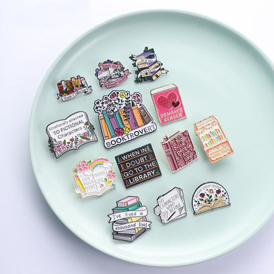 The "My Characters Won't Behave" Enamel Pin is an average-sized brooch featuring a stylised stack of pen and papers, with pile of crumpled sheets to pay tribute to just how naughty your characters are today. Only one way to get them back in order... keep going!