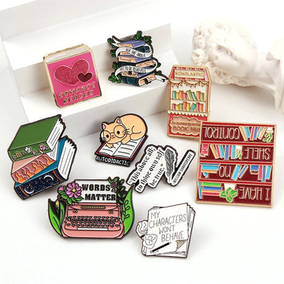 The "My Characters Won't Behave" Enamel Pin is an average-sized brooch featuring a stylised stack of pen and papers, with pile of crumpled sheets to pay tribute to just how naughty your characters are today. Only one way to get them back in order... keep going!