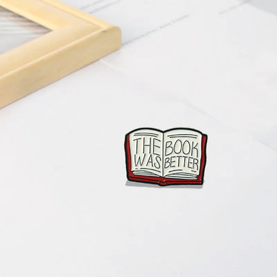 The "The Book Was Better" Enamel Pin features a stylised red book with large text loudly proclaiming just how much better the book was, as every book-lover knows.