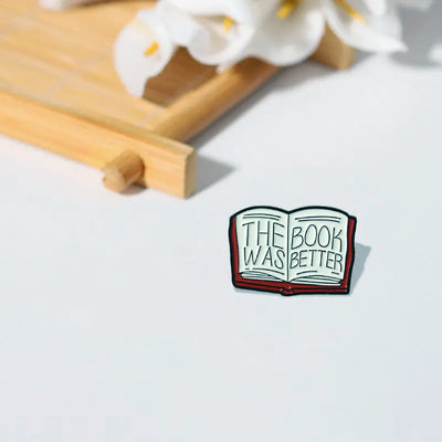 The "The Book Was Better" Enamel Pin features a stylised red book with large text loudly proclaiming just how much better the book was, as every book-lover knows.