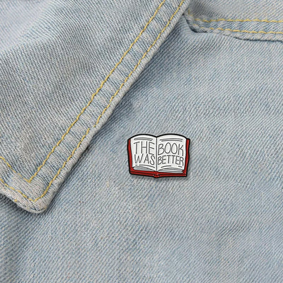 The "The Book Was Better" Enamel Pin features a stylised red book with large text loudly proclaiming just how much better the book was, as every book-lover knows.