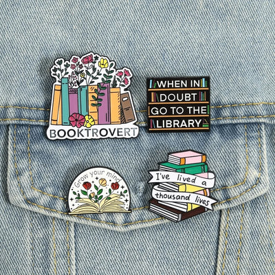 The "When In Doubt Go To The Library" Enamel Pin a large pin featuring a stylised bookshelf covered in books, and lettering proclaiming your love of all things library-related.