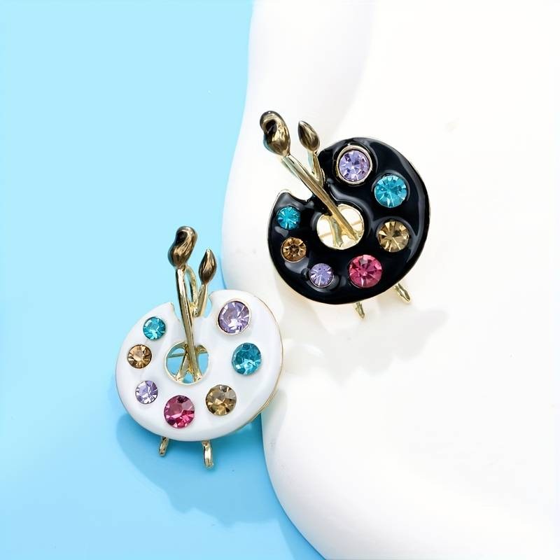 Frida Paint Palette Enamel Brooch - A medium-sized brooch decorated to look like an artist's paint palette, complete with paint brushes.