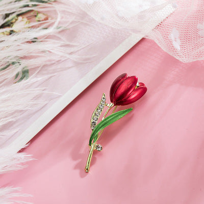 The Gretchen Enamel Tulip Brooch - A tall, slender enamel flower brooch with a colourful flower head and delicate round crystals along one of the leads.