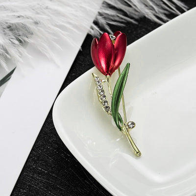 The Gretchen Enamel Tulip Brooch - A tall, slender enamel flower brooch with a colourful flower head and delicate round crystals along one of the leads.