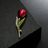 The Gretchen Enamel Tulip Brooch - A tall, slender enamel flower brooch with a colourful flower head and delicate round crystals along one of the leads.