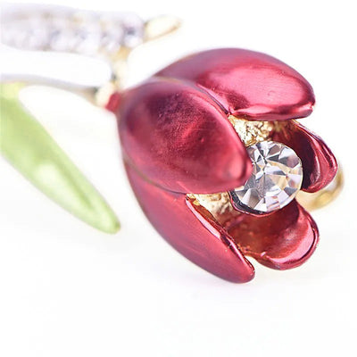 The Gretchen Enamel Tulip Brooch - A tall, slender enamel flower brooch with a colourful flower head and delicate round crystals along one of the leads.
