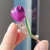 The Gretchen Enamel Tulip Brooch - A tall, slender enamel flower brooch with a colourful flower head and delicate round crystals along one of the leads.