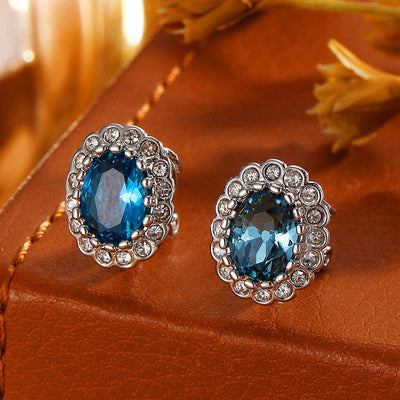 Hailee Entourage Clip Earrings - Ultra-petite, vintage-style clip-on earrings featuring a single coloured stone surrounded by 16 smaller stones.
