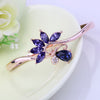 Helios Hinged Bangle - A beautiful bracelet with colourful crystals in an abstract starburst pattern.