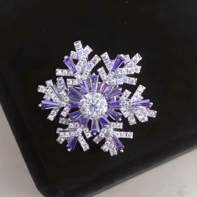 Hilde Rotatable Crystal Snowflake Brooch - A medium-sized crystal brooch featuring round white quartz and purple topaz arranged in a snowflake design.