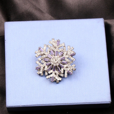 Hilde Rotatable Crystal Snowflake Brooch - A medium-sized crystal brooch featuring round white quartz and purple topaz arranged in a snowflake design.