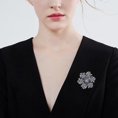 Hilde Rotatable Crystal Snowflake Brooch - A medium-sized crystal brooch featuring round white quartz and purple topaz arranged in a snowflake design.
