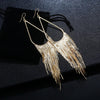 Jahzara Tassel Earrings - Long stylish statement dangles, featuring a hollow teardrop shape with tassels strung off it.