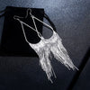 Jahzara Tassel Earrings - Long stylish statement dangles, featuring a hollow teardrop shape with tassels strung off it.