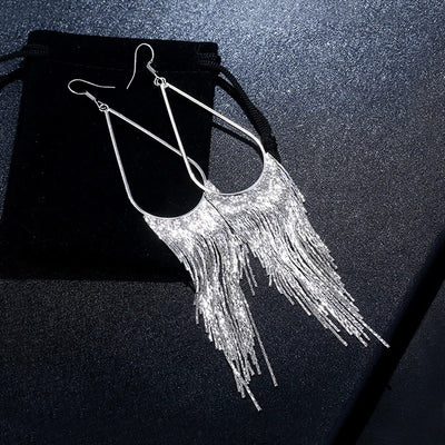 Jahzara Tassel Earrings - Long stylish statement dangles, featuring a hollow teardrop shape with tassels strung off it.
