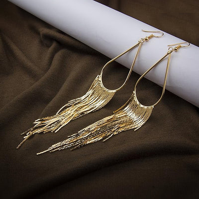 Jahzara Tassel Earrings - Long stylish statement dangles, featuring a hollow teardrop shape with tassels strung off it.