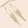 Jahzara Tassel Earrings - Long stylish statement dangles, featuring a hollow teardrop shape with tassels strung off it.