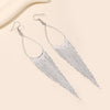Jahzara Tassel Earrings - Long stylish statement dangles, featuring a hollow teardrop shape with tassels strung off it.