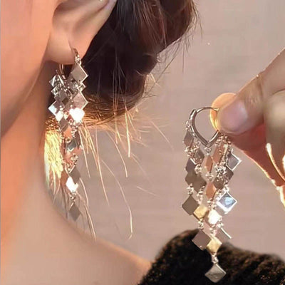 Janis Diamond Sequin Tassel Drop Earrings - Small lobe huggies with five strands of diamond-shaped metal charms strung below the lobe.