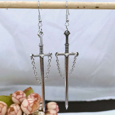 Joan Chained Crusader Sword Earrings - A long stylised silver sword charm attached to a standard french hook.