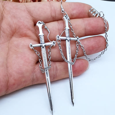 Joan Chained Crusader Sword Earrings - A long stylised silver sword charm attached to a standard french hook.