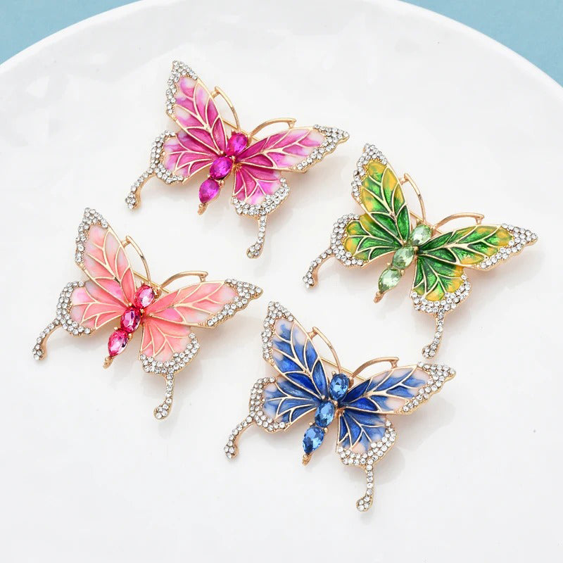 Josephine Butterfly Enamel Brooch - An adorable medium-sized brooch shaped like a stylised butterfly, available in blue, green, and two shades of pink.