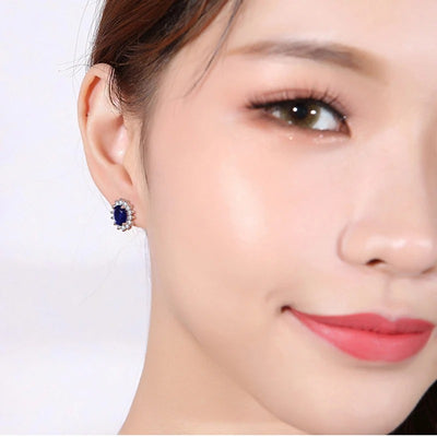 Juana Entourage Clip Earrings - A lovely, classic style earring featuring one large stone surrounded by 12 smaller stones.