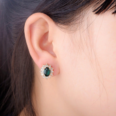 Juana Entourage Clip Earrings - A lovely, classic style earring featuring one large stone surrounded by 12 smaller stones.