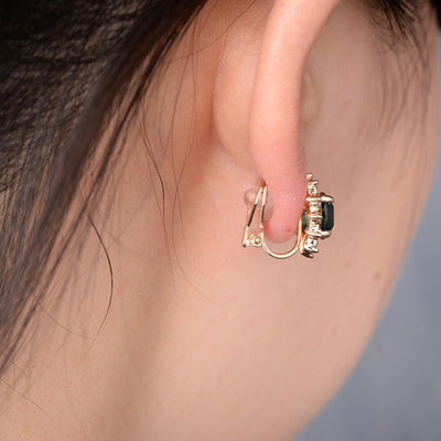 Juana Entourage Clip Earrings - A lovely, classic style earring featuring one large stone surrounded by 12 smaller stones.