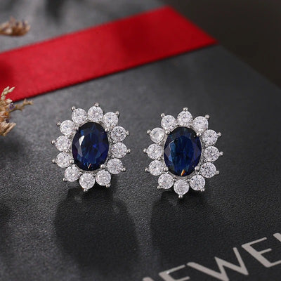 Juana Entourage Clip Earrings - A lovely, classic style earring featuring one large stone surrounded by 12 smaller stones.