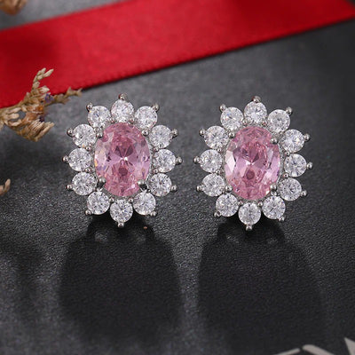 Juana Entourage Clip Earrings - A lovely, classic style earring featuring one large stone surrounded by 12 smaller stones.