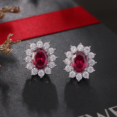 Juana Entourage Clip Earrings - A lovely, classic style earring featuring one large stone surrounded by 12 smaller stones.