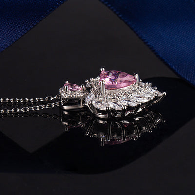 Katherine Luxury Crystal Pendant - A beautiful crystal pendant featuring a pink or blue topaz heart in the centre, surrounded by white topaz stones arranged to look like angel wings.