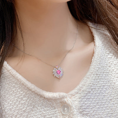 Katherine Luxury Crystal Pendant - A beautiful crystal pendant featuring a pink or blue topaz heart in the centre, surrounded by white topaz stones arranged to look like angel wings.