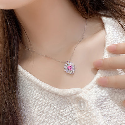 Katherine Luxury Crystal Pendant - A beautiful crystal pendant featuring a pink or blue topaz heart in the centre, surrounded by white topaz stones arranged to look like angel wings.