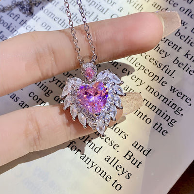 Katherine Luxury Crystal Pendant - A beautiful crystal pendant featuring a pink or blue topaz heart in the centre, surrounded by white topaz stones arranged to look like angel wings.