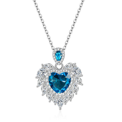 Katherine Luxury Crystal Pendant - A beautiful crystal pendant featuring a pink or blue topaz heart in the centre, surrounded by white topaz stones arranged to look like angel wings.