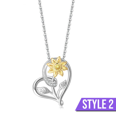 The Kelly Sunflower Heart Necklace - An elegant floral-themed necklace featuring a platinum plated heart with a beautiful yellow gold sunflower, and sparkling crystals.