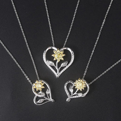 The Kelly Sunflower Heart Necklace - An elegant floral-themed necklace featuring a platinum plated heart with a beautiful yellow gold sunflower, and sparkling crystals.