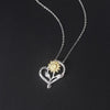 The Kelly Sunflower Heart Necklace - An elegant floral-themed necklace featuring a platinum plated heart with a beautiful yellow gold sunflower, and sparkling crystals.