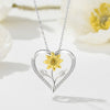 The Kelly Sunflower Heart Necklace - An elegant floral-themed necklace featuring a platinum plated heart with a beautiful yellow gold sunflower, and sparkling crystals.