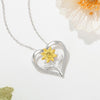 The Kelly Sunflower Heart Necklace - An elegant floral-themed necklace featuring a platinum plated heart with a beautiful yellow gold sunflower, and sparkling crystals.