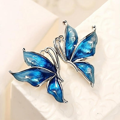 Lacquer Wings Enamel Earrings - Vibrantly colourful enamel earrings with a butterfly motif, available in blue, green, orange, and purple.