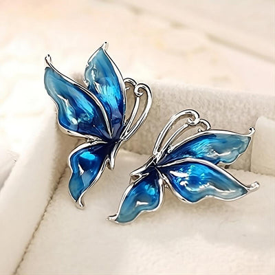 Lacquer Wings Enamel Earrings - Vibrantly colourful enamel earrings with a butterfly motif, available in blue, green, orange, and purple.