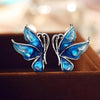 Lacquer Wings Enamel Earrings - Vibrantly colourful enamel earrings with a butterfly motif, available in blue, green, orange, and purple.