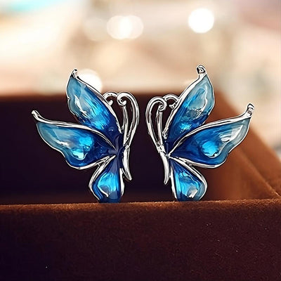 Lacquer Wings Enamel Earrings - Vibrantly colourful enamel earrings with a butterfly motif, available in blue, green, orange, and purple.