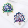 Lakshmi Crystal Peacock Brooch - A lovely stylized peacock brooch featuring glossy enamel paint and sparkling crystals.